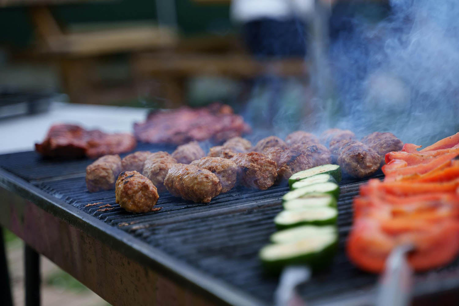 Meatballs, zucchini, and tomato on the barbecue 